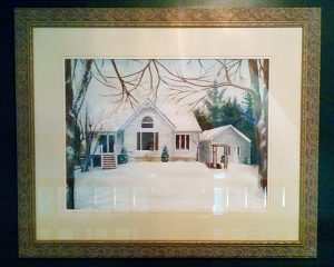 Framed painting of pretty home in winter time.