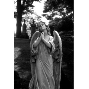Black and white photograph of tombstone angel in cemetary in Picton, Ontario