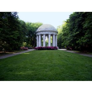 photo of columned gazebo with dome roof in amongst trees and purple flowers