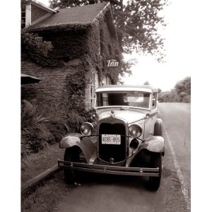 Photograph: Antique car in front of an ivy colvered inn